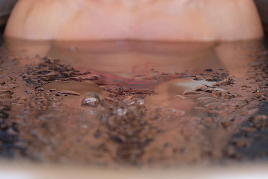 Close-up of a person submerged in an ice bath, demonstrating proper breathing techniques for a cold plunge.